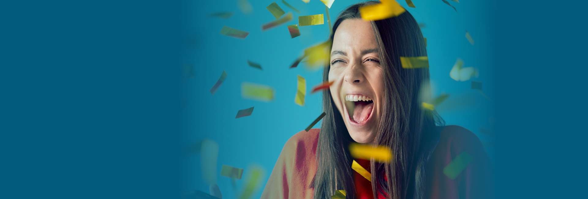 Woman celebrating with confetti falling around her